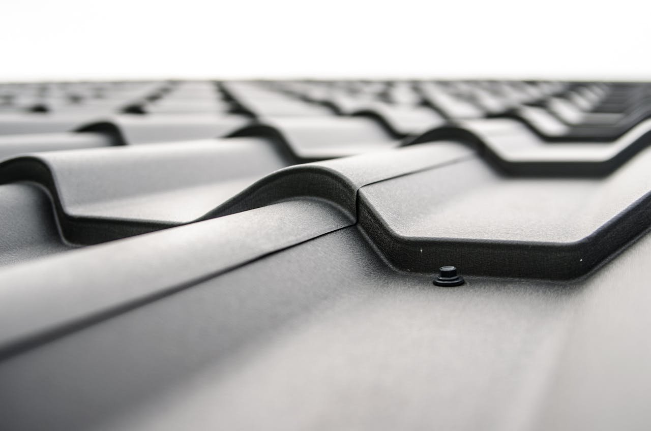 Close-up view of a metal roofs wavy design showcasing rivets and structural detail.